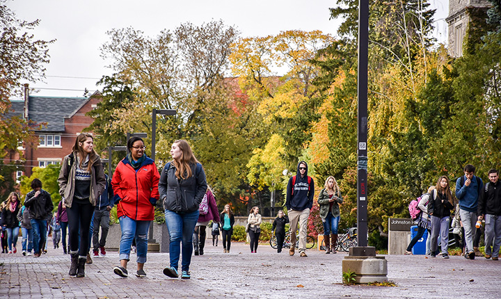 Students walking down a brick pathway through  the U of G campus