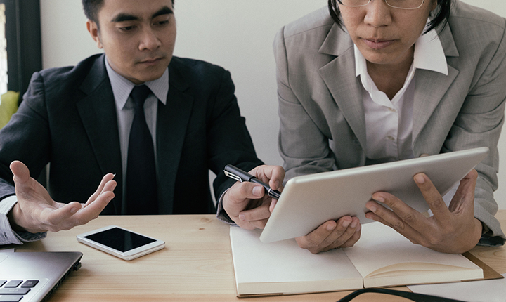 Two business people looking at a tablet