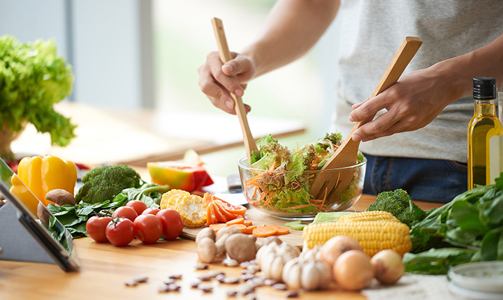 Person mixing a salad