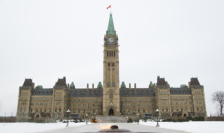 Canadian parliament building with cauldron burning
