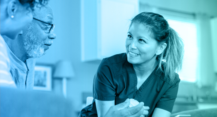 Female PSW smiling at two clients.