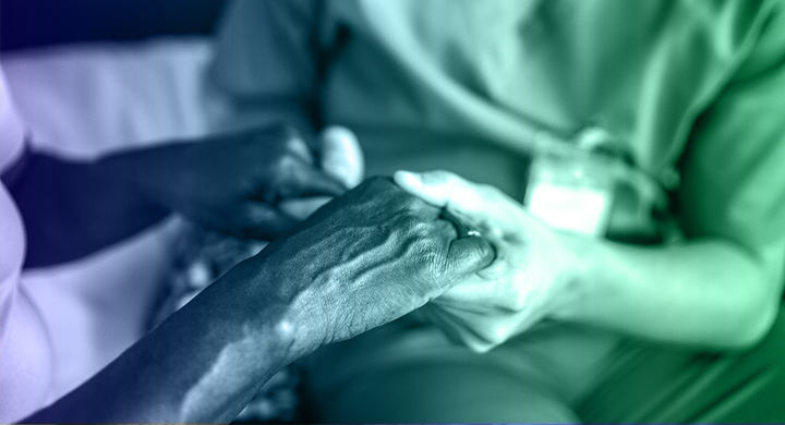 Close-up of a PSW holding a client's hand.