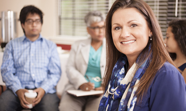 Multi-ethnic group of people in counseling session with therapist